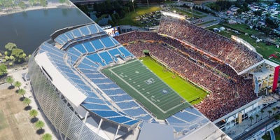 Split screen of current Camping World Stadium and concept art of new renovation